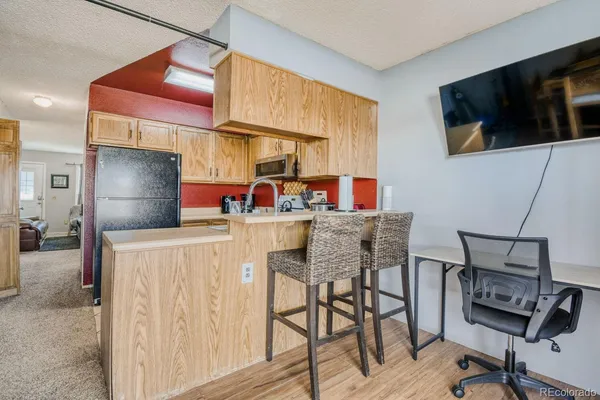 a dining room with a table chairs and a flat screen tv