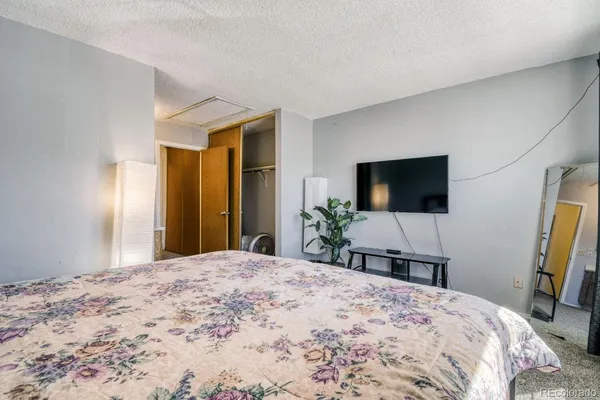 a bedroom with a bed and a flat screen tv