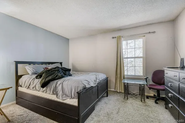a bed sitting in a bedroom next to a window