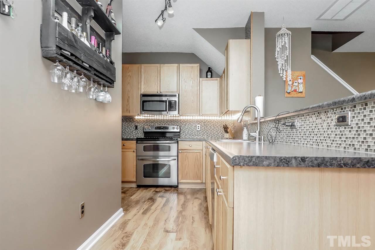 2341 Persimmon Ridge Drive Raleigh, NC 27604 - Photo 12 of 25 a kitchen with stainless steel appliances granite countertop a sink and a stove