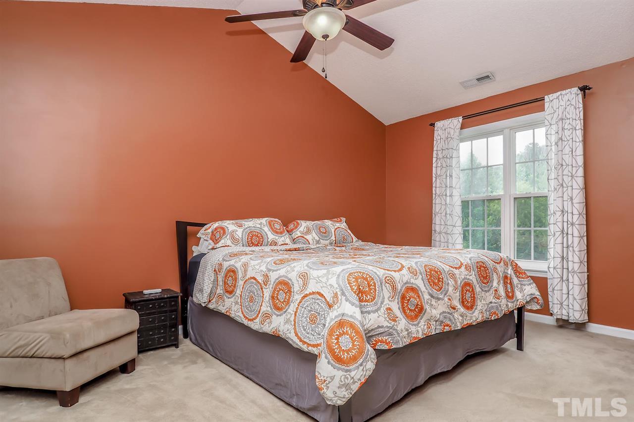 2341 Persimmon Ridge Drive Raleigh, NC 27604 - Photo 19 of 25 a bedroom with a bed couch and window