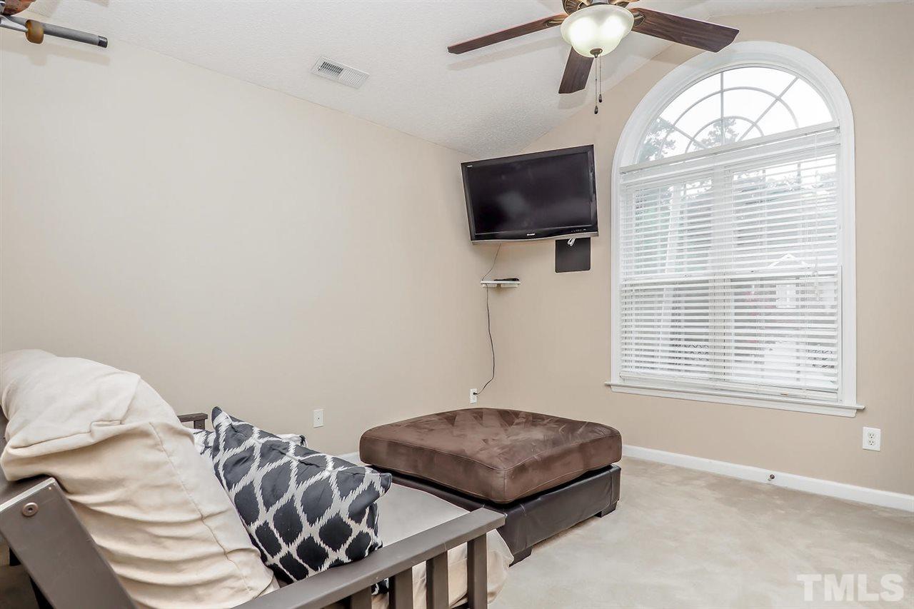 2341 Persimmon Ridge Drive Raleigh, NC 27604 - Photo 23 of 25 a bedroom with furniture and a flat screen tv