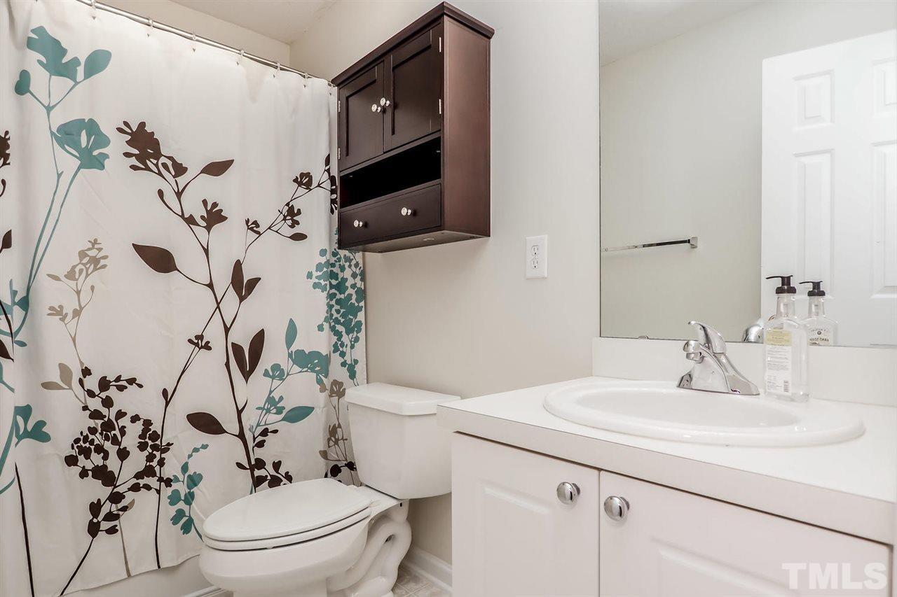 2341 Persimmon Ridge Drive Raleigh, NC 27604 - Photo 24 of 25 a bathroom with a sink and mirror with toilet
