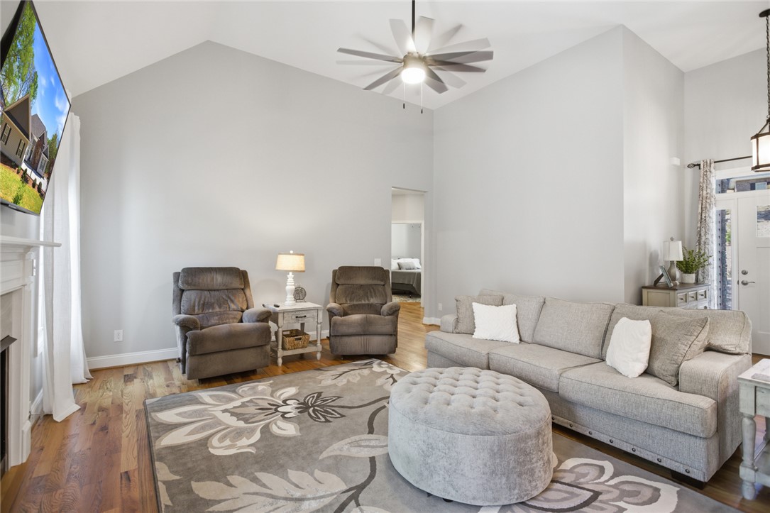105 Winterbrook Circle Seneca, SC 29678 - Photo 6 of 48 This living room features vaulted ceilings and rich hardwood flooring.