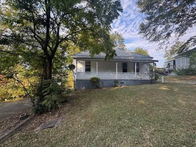 a front view of house with yard and trees