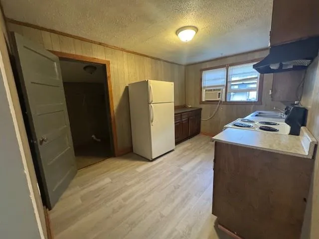 a kitchen with stainless steel appliances a refrigerator and a stove