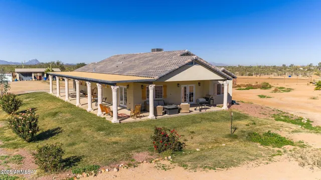 a view of a house with backyard patio and swimming pool