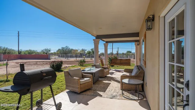 a view of a patio with couches chairs and a potted plant