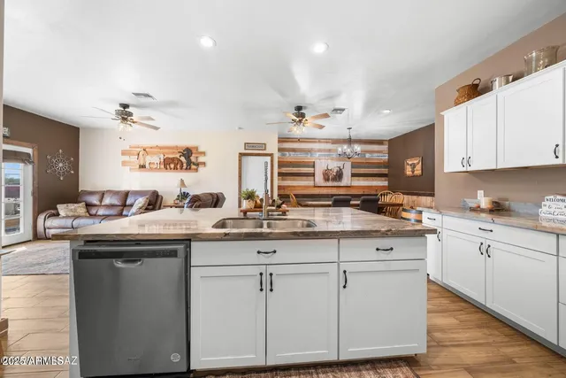 a kitchen with granite countertop a sink and cabinets