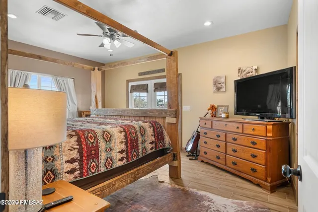 a bedroom with a bed and flat screen tv