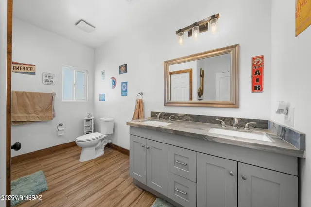 a bathroom with a toilet sink and mirror