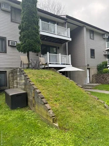 a view of a house with pool and a yard