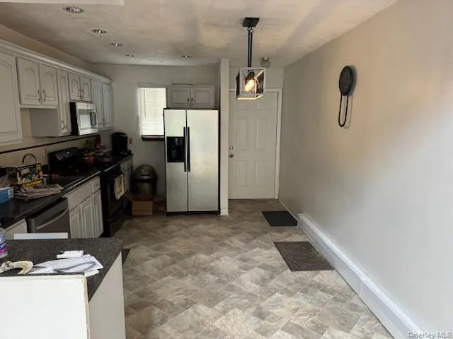 a kitchen with refrigerator and window