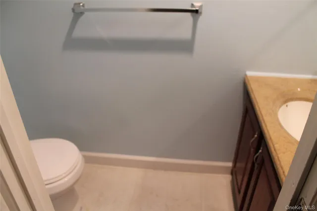 a white toilet sitting next to a white sink