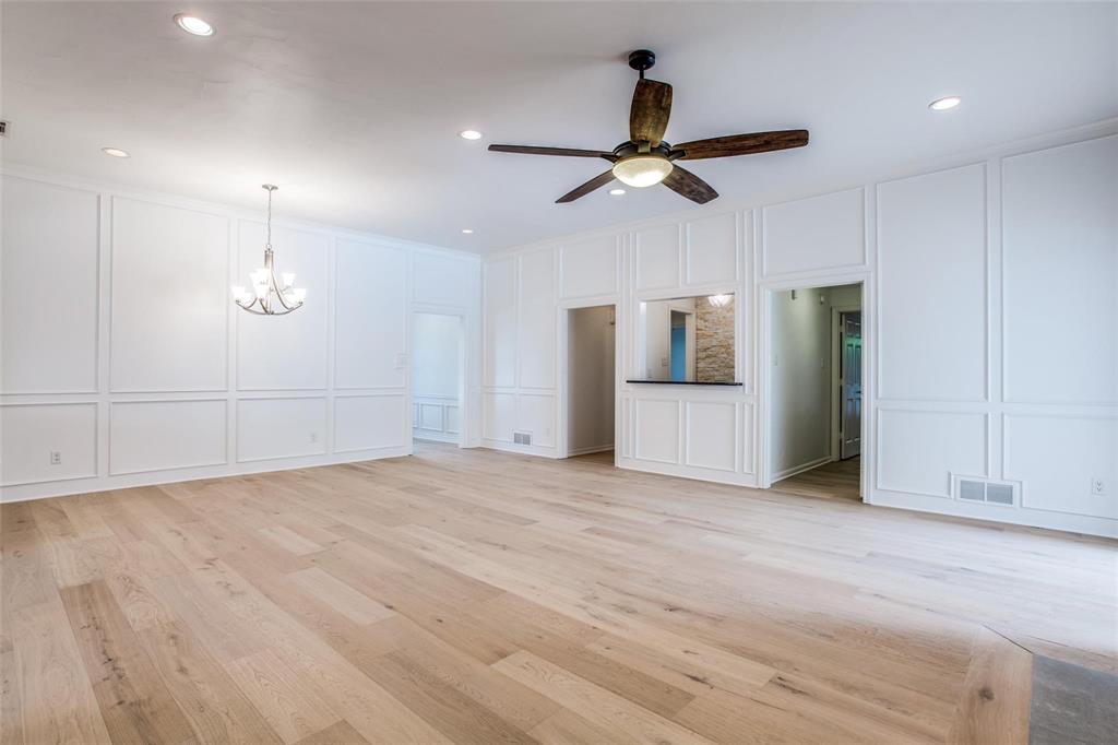 6926 Northwood Road Dallas, TX 75225 - Photo 9 of 29 a view of empty room with wooden floor and ceiling fan