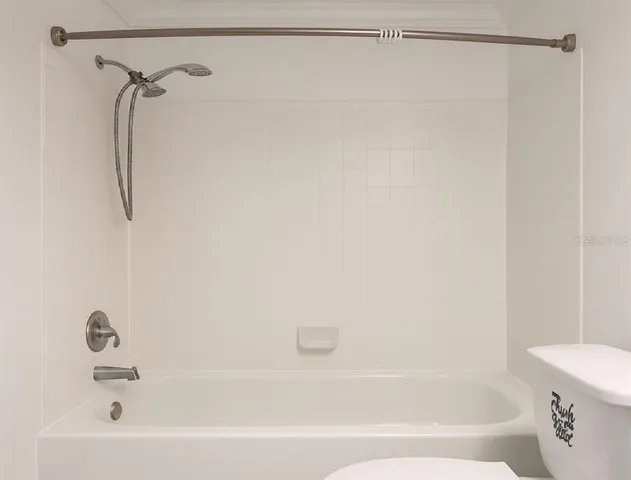a bathroom with a shower and a bath tub