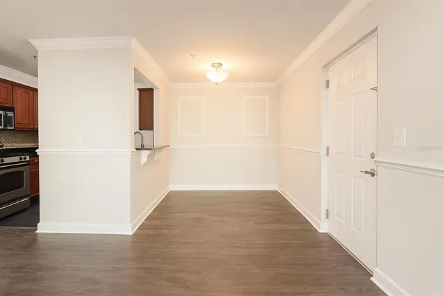 a view of a hallway with wooden floor