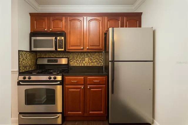 a kitchen with a refrigerator and a stove