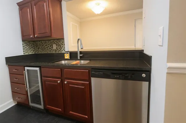 a kitchen with a sink a stove and a microwave