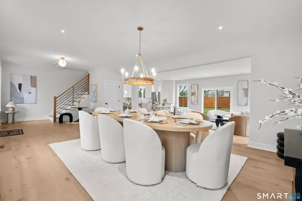 a dining table with chairs and chandelier