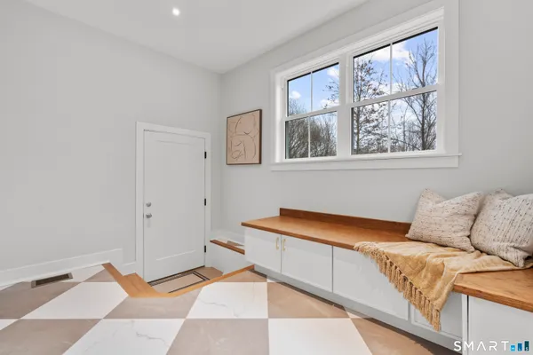 a bed room with a bed and a painting on the wall