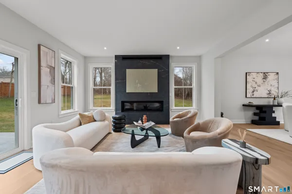a living room with furniture and large windows