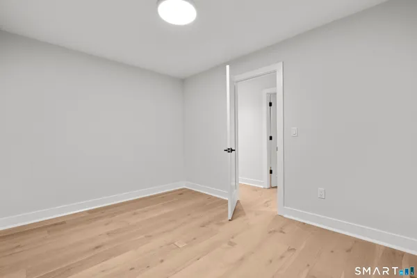 a view of a livingroom with furniture window and wooden floor