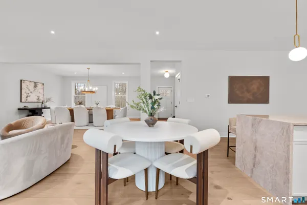 a view of a dining room with furniture and wooden floor