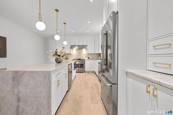 a kitchen with stainless steel appliances a stove a sink and a refrigerator
