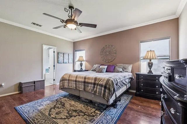 a bedroom with a bed rug and dresser