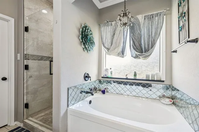 a bathroom with a bathtub a shower and a sink