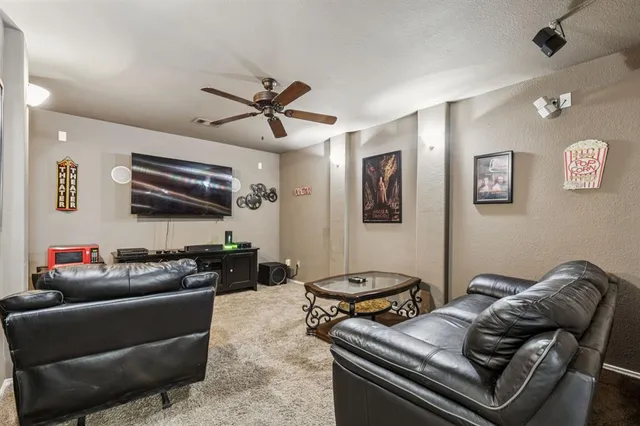 a living room with furniture ceiling fan and a wooden floor