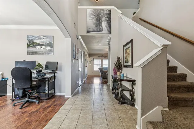 a view of a hallway with workspace and wooden floor
