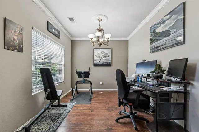 a view of a workspace with furniture and a window