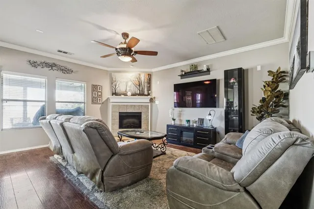a living room with furniture ceiling fan and a fireplace