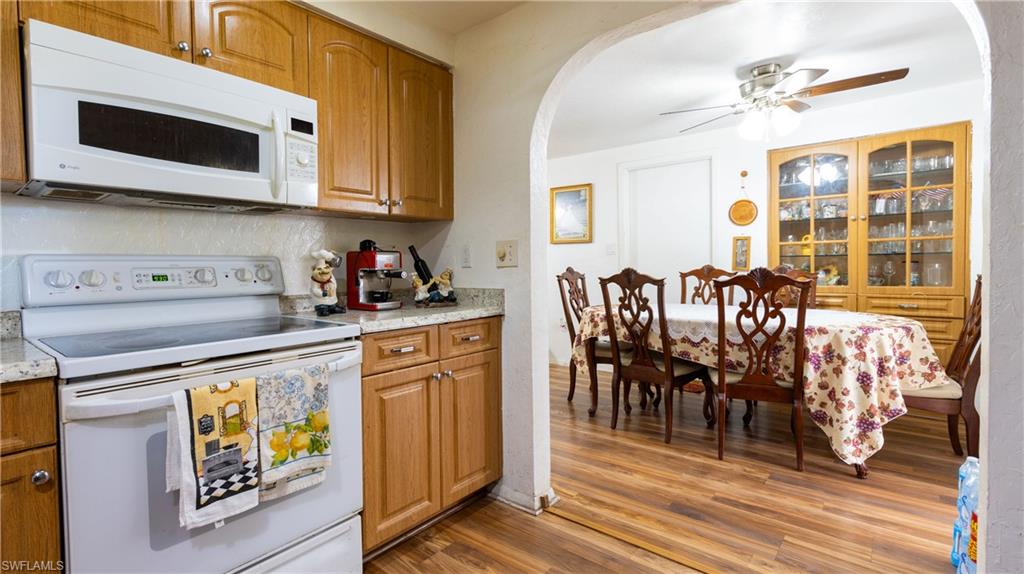 1230 Ramsdel Street Port Charlotte, FL 33952 - Photo 14 of 37 a kitchen with stainless steel appliances granite countertop wooden cabinets a dining table and chairs