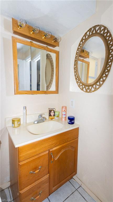 1230 Ramsdel Street Port Charlotte, FL 33952 - Photo 23 of 37 a bathroom with a sink a mirror and a toilet