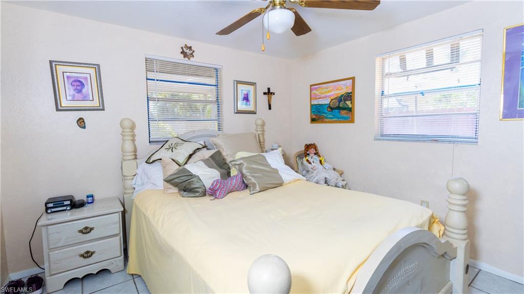 1230 Ramsdel Street Port Charlotte, FL 33952 - Photo 27 of 37 a bedroom with a bed and wooden floor