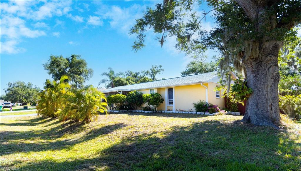 1230 Ramsdel Street Port Charlotte, FL 33952 - Photo 3 of 37 a view of swimming pool with a garden and trees
