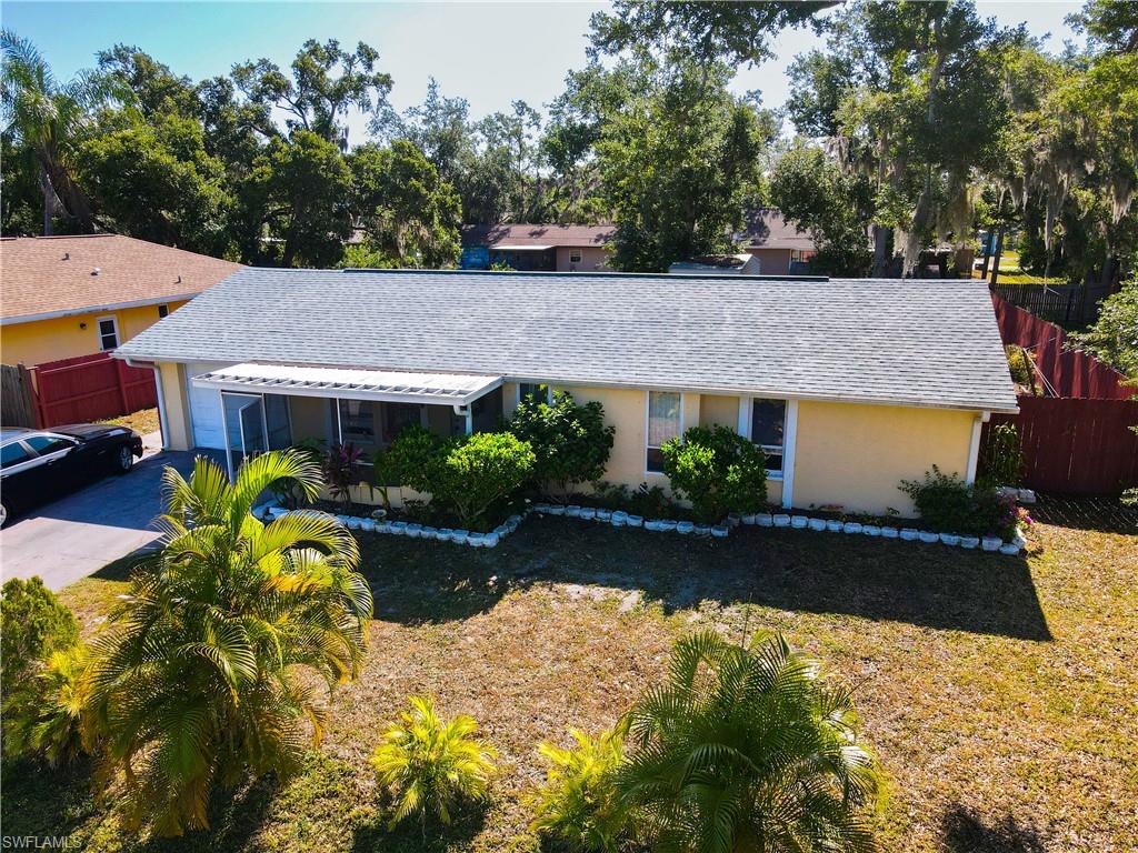 1230 Ramsdel Street Port Charlotte, FL 33952 - Photo 36 of 37 a aerial view of a house with a yard and large trees