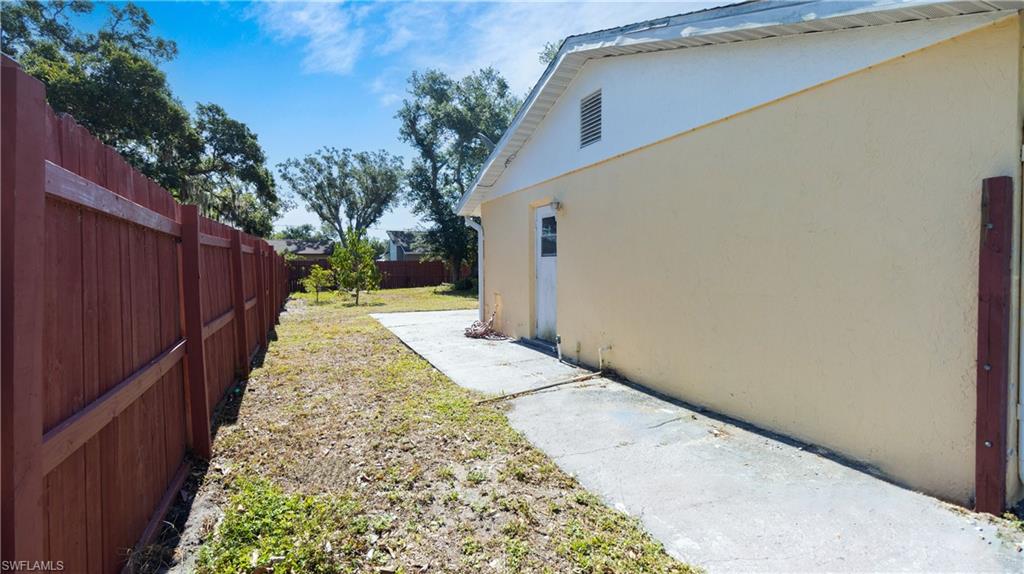 1230 Ramsdel Street Port Charlotte, FL 33952 - Photo 7 of 37 a pathway of a house with a yard