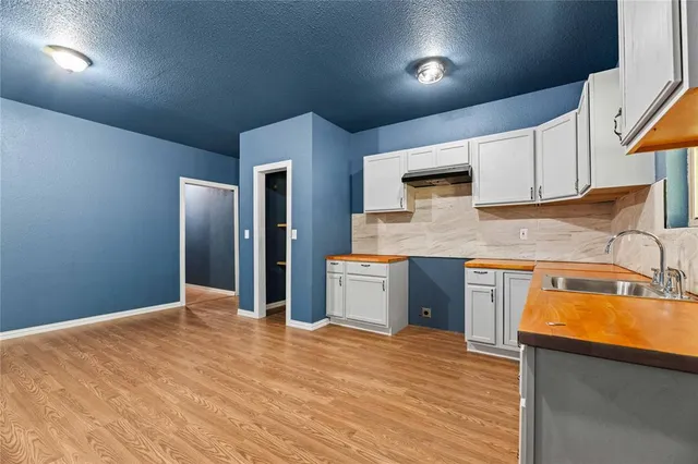 a kitchen with stainless steel appliances granite countertop a sink a stove and a refrigerator