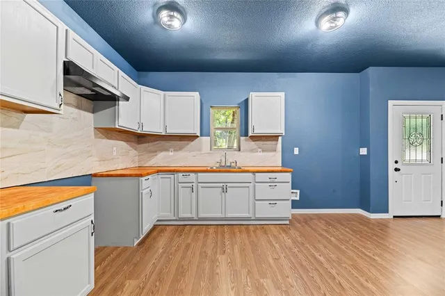 a kitchen with stainless steel appliances granite countertop a sink and cabinets