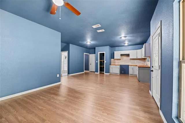 a view of a kitchen with a sink and a refrigerator