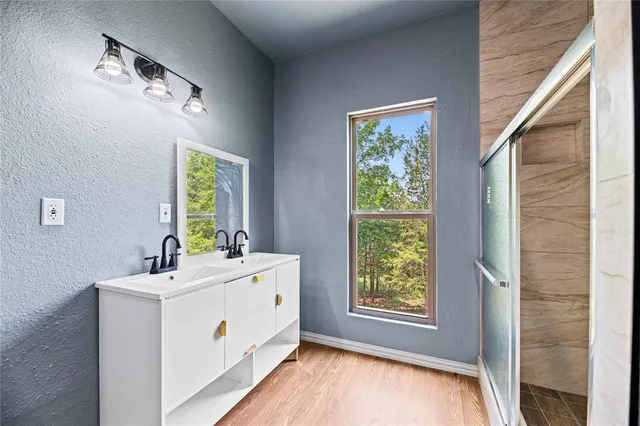 a bathroom with a sink a mirror and a window