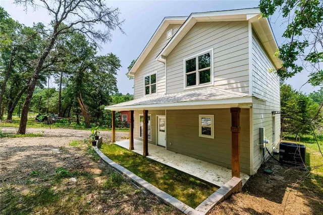 a view of house with backyard