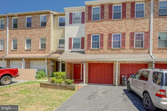 a front view of a building with parking space