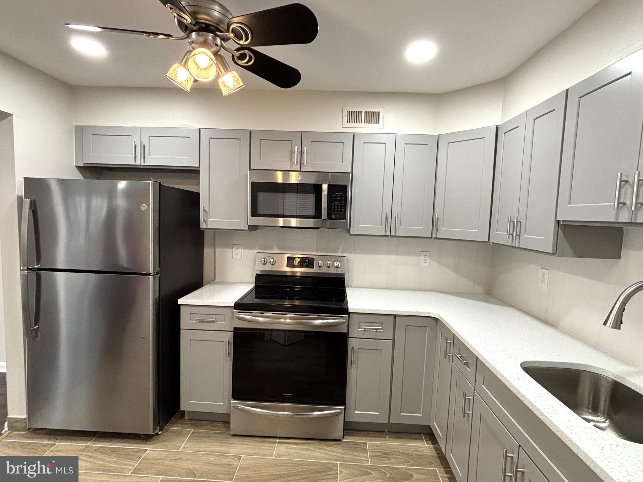 104 Chaucer Road, Unit A Mount Laurel, NJ 08054 - Photo 11 of 20 a kitchen with a stainless steel appliances cabinets and a sink
