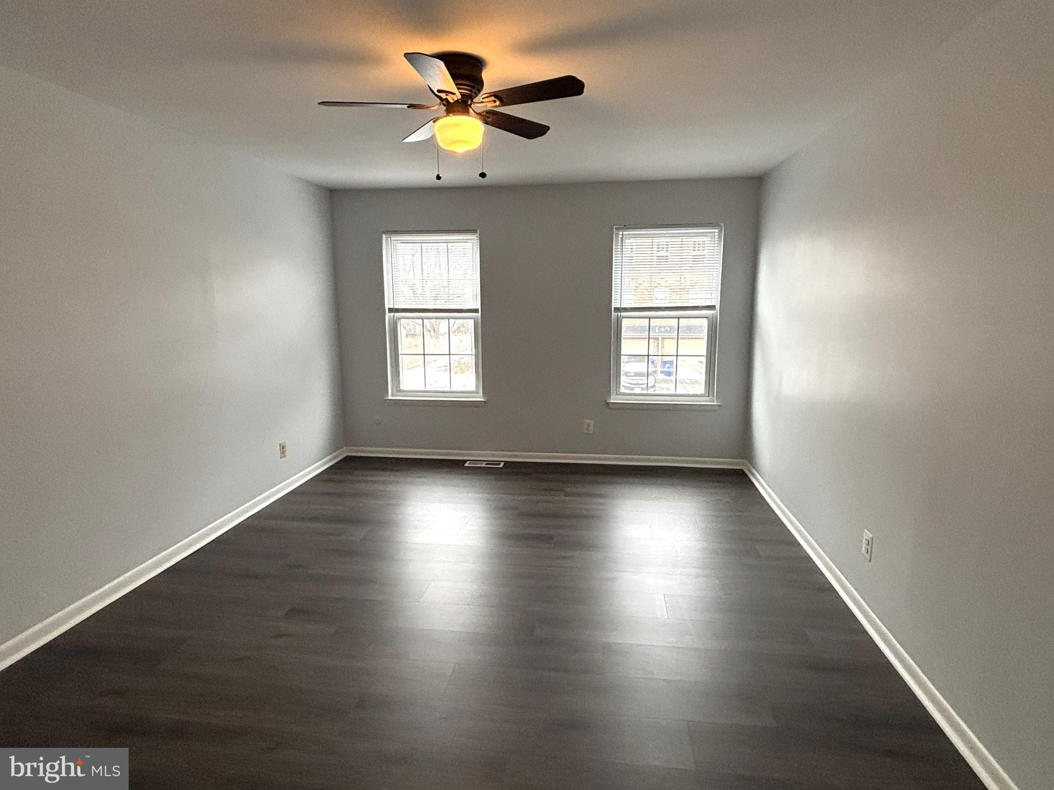 104 Chaucer Road, Unit A Mount Laurel, NJ 08054 - Photo 18 of 20 a view of an empty room with a window and wooden floor