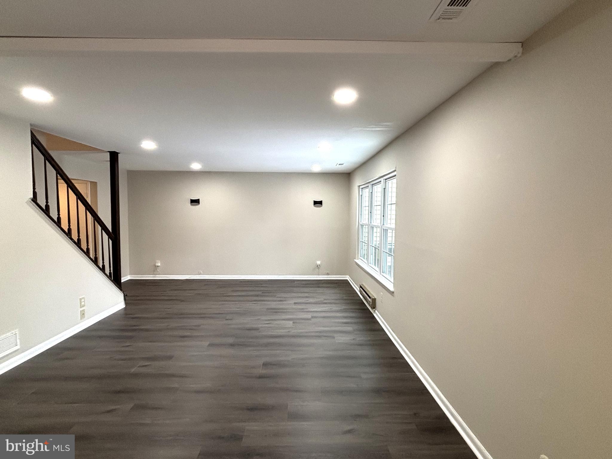 104 Chaucer Road, Unit A Mount Laurel, NJ 08054 - Photo 7 of 20 a view of an empty room with wooden floor and stairs
